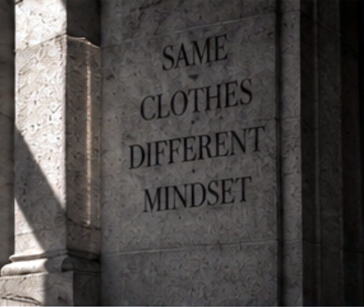 BARE BONES design philosophy carved stone wall reading Same Clothes Different Mindset